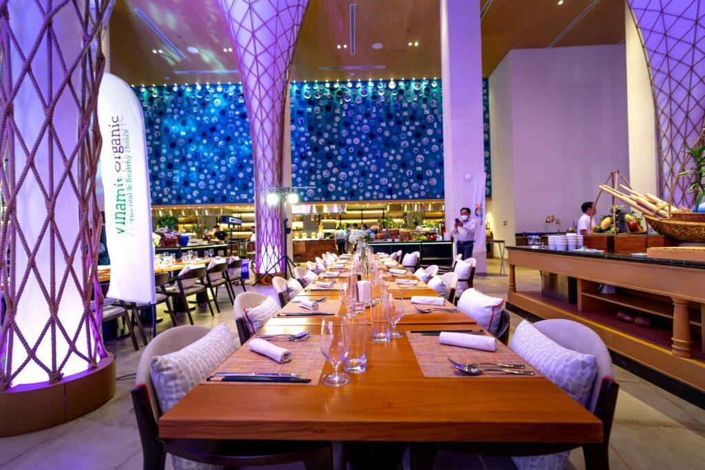 A beautifully decorated empty dining hall with modern design elements and vibrant lighting.