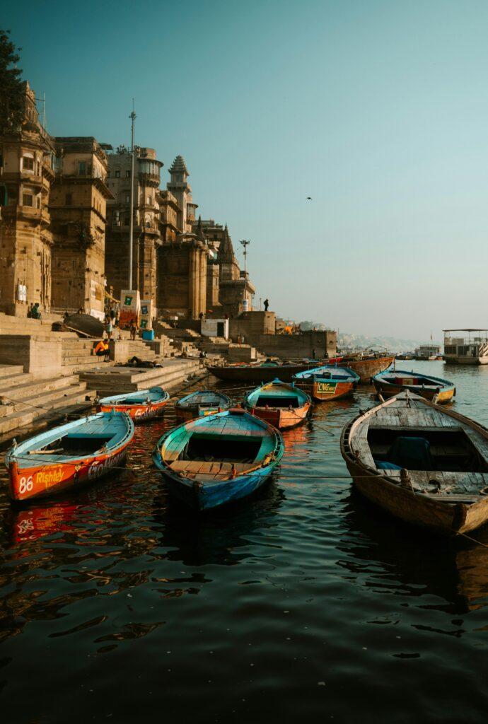 A serene view of colorful boats at the Varanasi ghats, capturing India's spiritual essence.