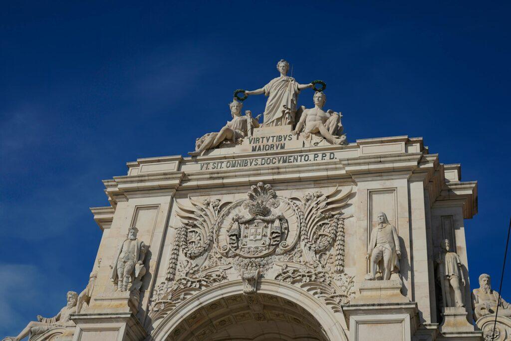 The majestic Arco da Rua Augusta in Lisbon, Portugal, under a clear blue sky.