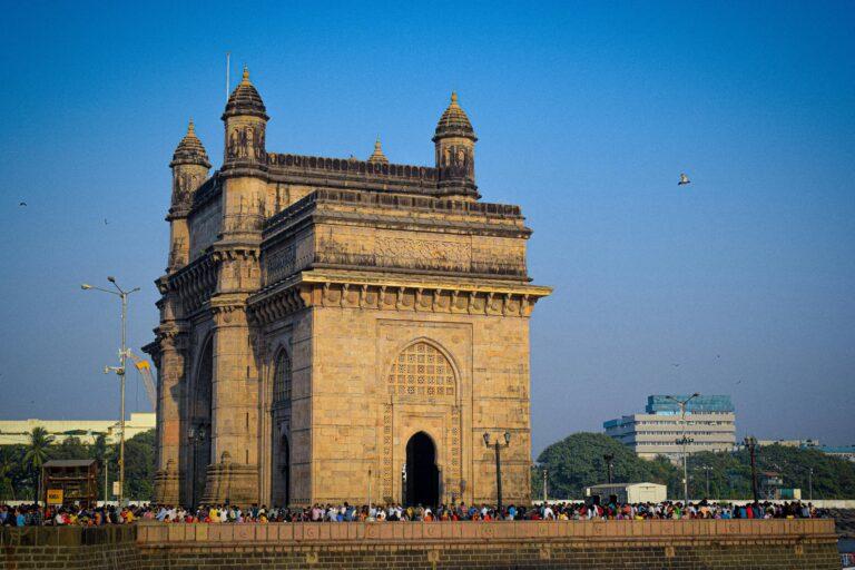 The iconic Gateway of India in Mumbai, a popular tourist attraction and historical landmark, on a sunny day.